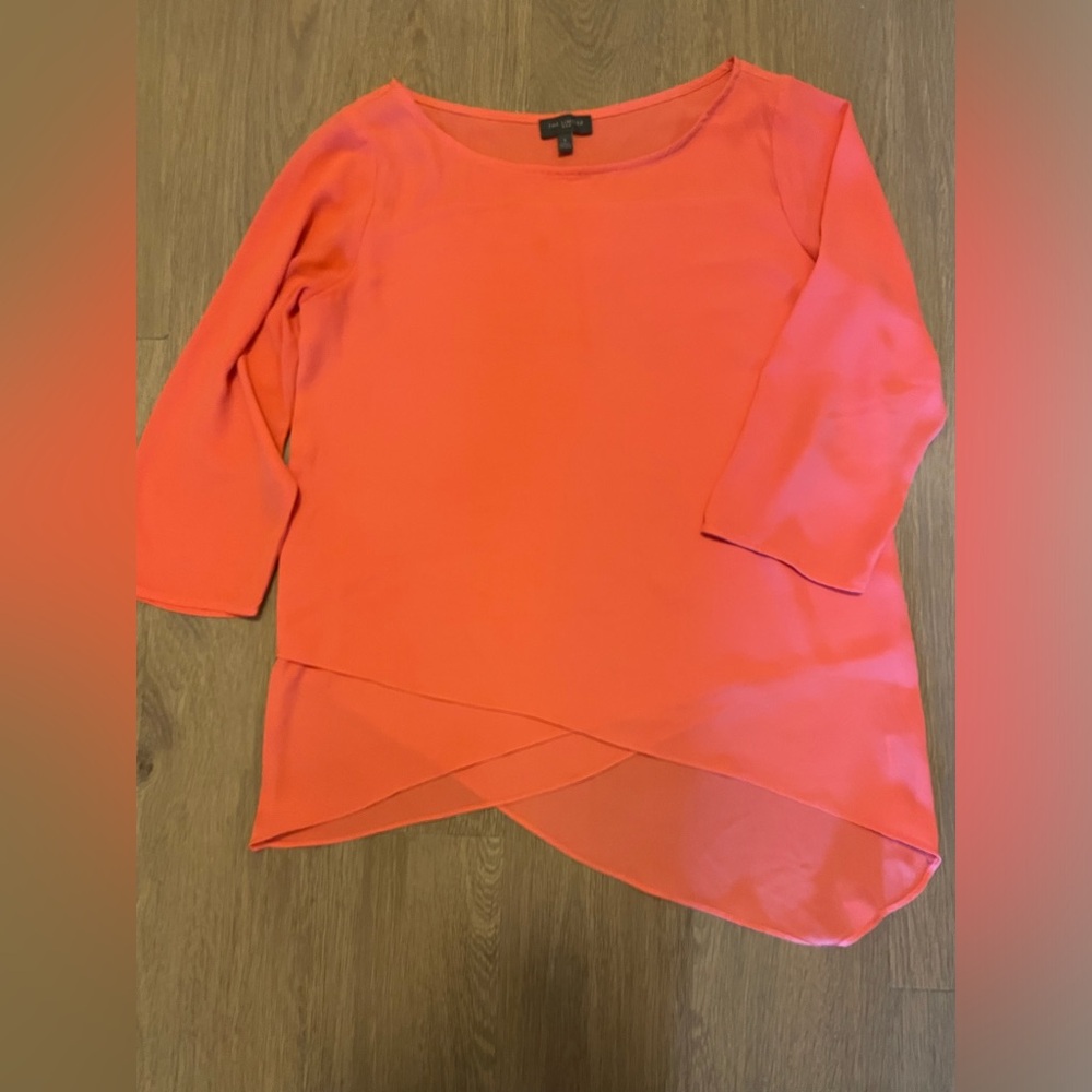 Beautiful coral top with layered material and asymmetrical bottom.